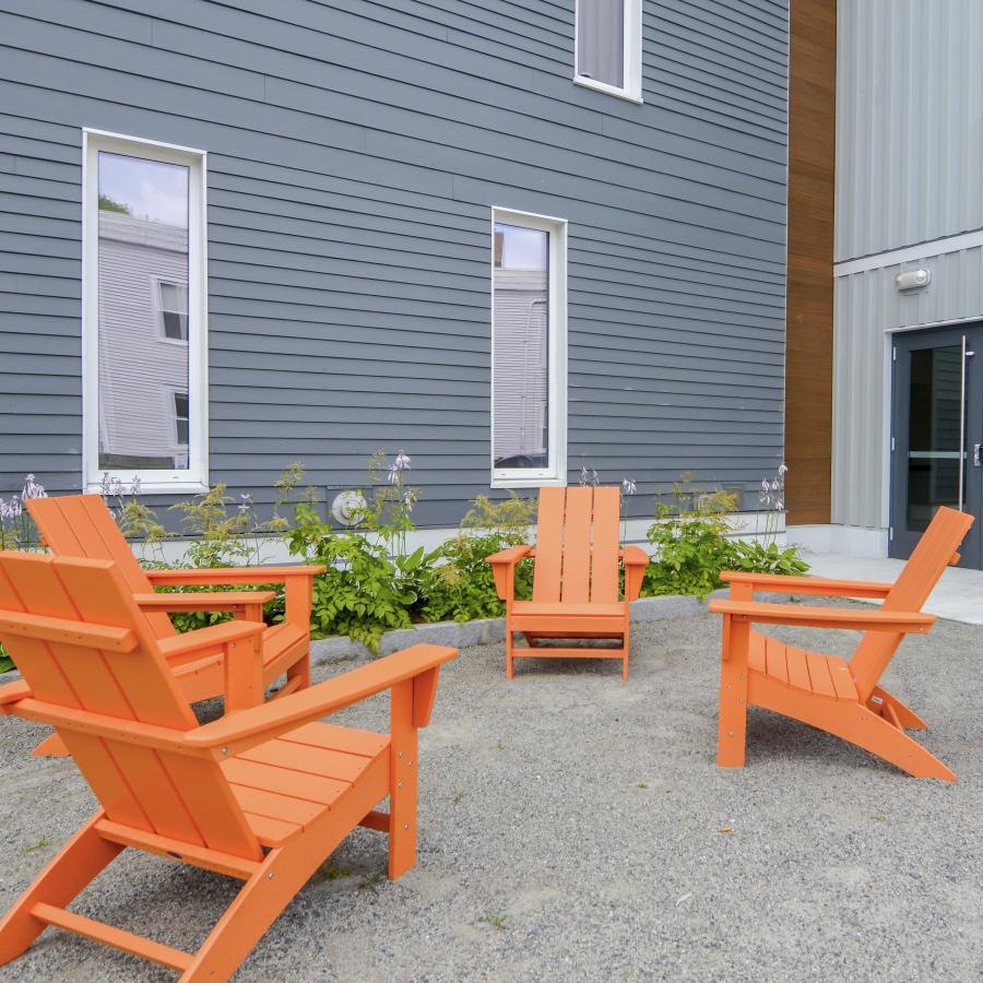 Take advantage of all 31 Tufts Landing has to offer a group of chairs outside a house