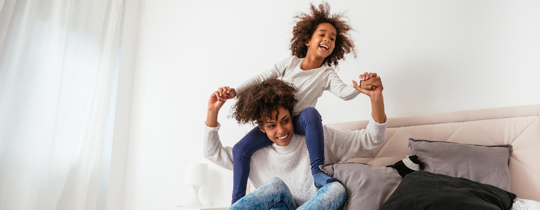 Relax and recharge in beautiful and spacious bedrooms mother and daughter happily play on a large bed